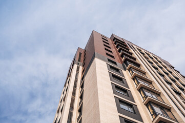 Fototapeta premium low-angle view of a multi-storey apartment building. New residential complex in the city