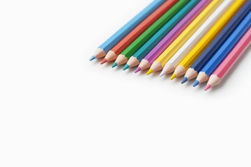 Fototapeta premium several colored pencils are lined up on a white surface