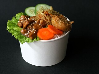 Teriyaki glazed chicken rice bowl with vegetables, noodle, sliced cucumber and wortel and mashed...
