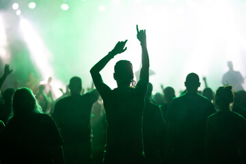 Crowd at concert and blurred stage lights.