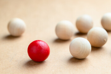 A red wooden ball that is different from the normal wooden balls