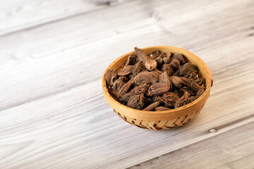 Black cardamoms or Greater Cardamoms on wooden table	
