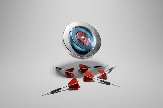 Darts and target with a bullseye on a plain background