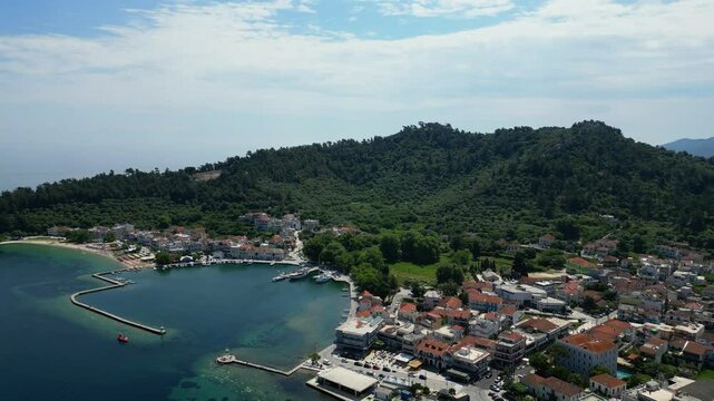 4K Aerial View of Thasos Town, Greece. Marina and Mountainous Landscape on a stunning clear day
