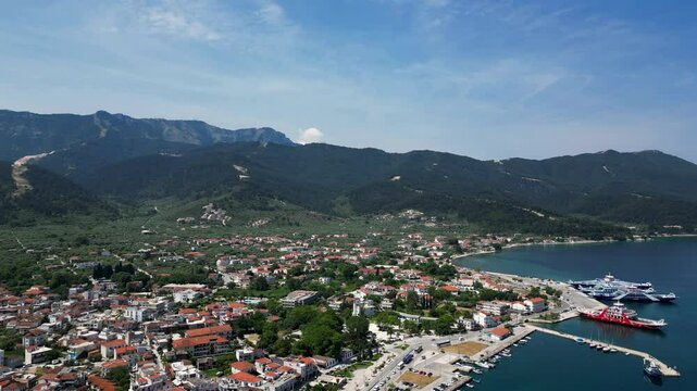 4K Aerial View of Thasos Town, Greece. Marina and Mountainous Landscape on a stunning clear day