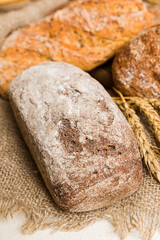 Homemade natural breads. Different kinds of fresh bread as background, perspective view with copy space