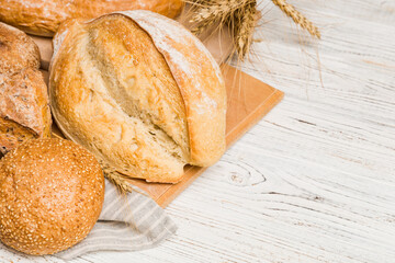 Homemade natural breads. Different kinds of fresh bread as background, perspective view with copy space