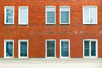 Windows on the facade of an old red brick building