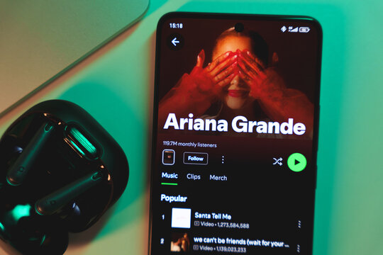 A smartphone displaying Ariana Grande's artist profile on Spotify.
