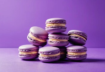 A pile of purple macarons on a violet background