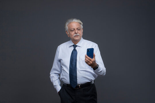 Old Man Is Staring At His Phone