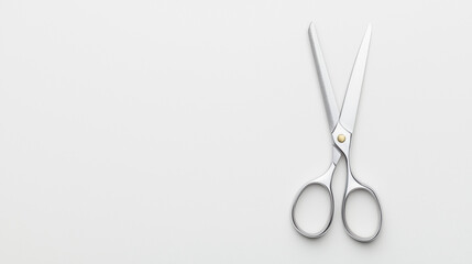 Sharp Scissors on White: A pair of sleek, silver scissors rests against a pristine white background, their sharp blades gleaming in the light. The simple yet powerful image evokes themes of precision.