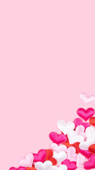 Pink pastel background with negative space and border of small silky hearts. Vertical 9:16 format