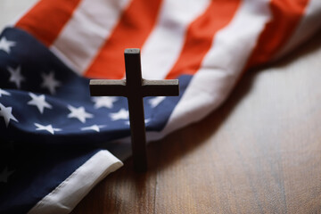 Wooden Cross with American Flag on Wooden Surface Representing Faith and Patriotism