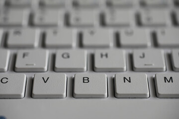 Close-Up Shot of a Keyboard with Focus on V, B, and N Keys in a Monochromatic Scheme
