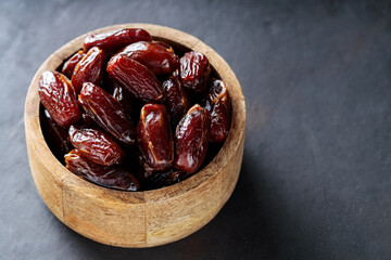 Organic Dried Dates in Rustic Wooden Bowl, Ramadan and Middle Eastern Cuisine