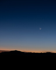 Moon after sunset on the mountains.