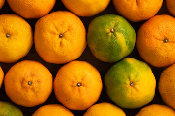 Fresh juicy tangerine mandarin orange on wooden table background.