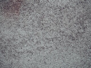 Rough concrete wall with subtle cracks, with partially colored top left corner