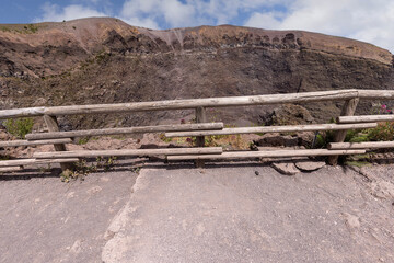 Footpath with a wooden barrier on slope of Mount Vesuvius volcano, Naples, Italy
