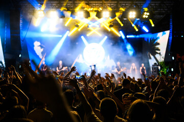Crowd enjoying vibrant live concert with dynamic lighting