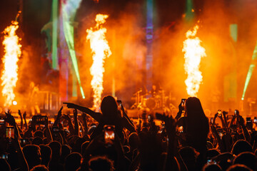 Crowd immersed in a fiery and vibrant concert performance