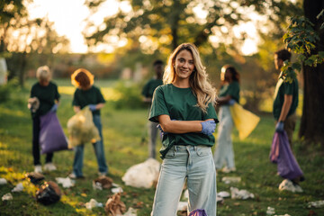 Young woman volunteering collecting trash in park