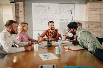 Marketing professionals collaborating on project during team meeting