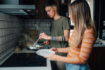 Lesbian couple cooking together in modern kitchen