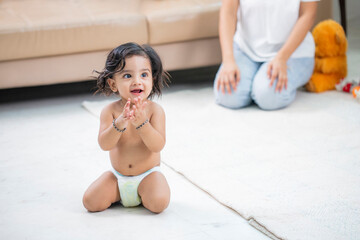 Smiling Baby Wearing Nappy Clapping Hands Looking At Camera