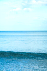 Beautiful bright blue sea with smooth waves, bright sky background, beautiful clouds.