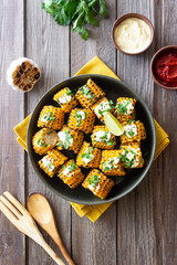 Grilled corn with white sauce and herbs. BBQ. Picnic. Vegetarian food. Diet.