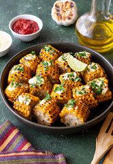 Grilled corn with white sauce and herbs. BBQ. Picnic. Vegetarian food. Diet.