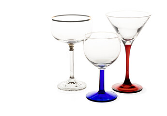 Isolated empty drinking glasses on white background, set of wine or sherry, champagne and cocktail glasses with colored stems on white, copy space 