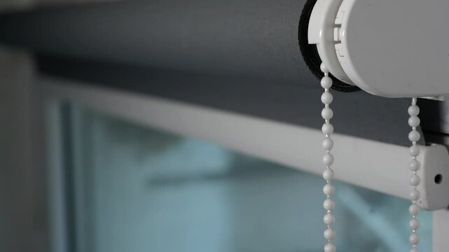 mechanism of roller blinds indoors,Close-up. Roller shutter system day and night opens the window. roller blinds on the window