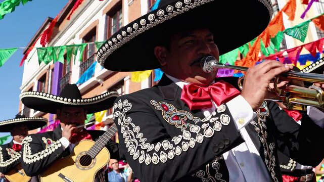 Mariachi musicians perform lively music during a vibrant cultural festival in Mexico, showcasing traditional attire and instruments