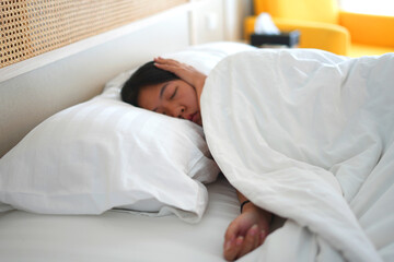 Sick young asian woman feeling sad, tired, stressed and worried suffering depression in mental health, sitting and lying on bed, covering her ears and cannot sleep well from insomnia, mental problem.