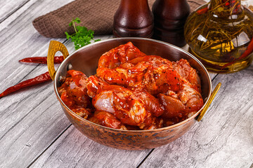 Raw marinated buffalo chicken wings