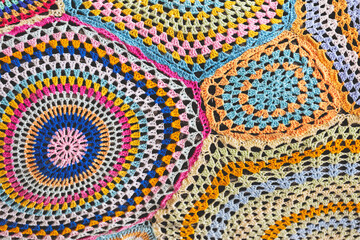 Multicolored background knitted from threads as a texture, pattern.