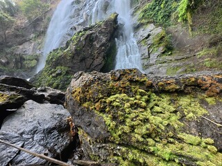 Khlonglan waterfall with moss in rainforest.