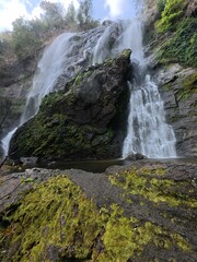 Khlonglan waterfall with moss in rainforest.