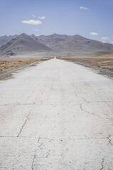 Asphalt road of the Pamir Highway in the valley of the Tien Shan Mountains in Tajikistan in the...