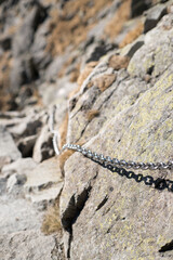 Belaying, chains in difficult places on a high mountain trail in the High Tatras.
