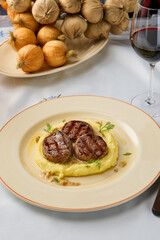 Elegant Veal Medallions with Creamy Mashed Potatoes in Soft Natural Lighting