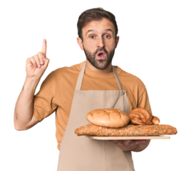 Hispanic male baker with bread tray having some great idea, concept of creativity.