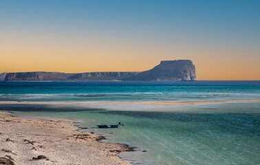 a beautiful sunset on the deserted beach with the turquoise sea