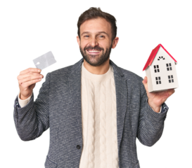 Hispanic male businessman with credit card and house model