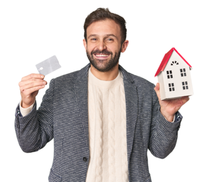 Hispanic male businessman with credit card and house model