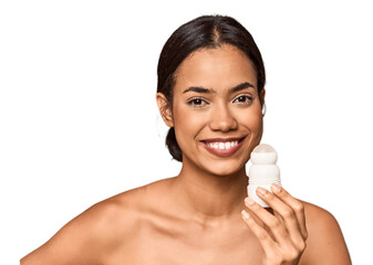 Filipino woman holds deodorant in studio showing a copy space on a palm and holding another hand on...