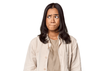 Portrait of a young Filipino woman confused, feels doubtful and unsure.